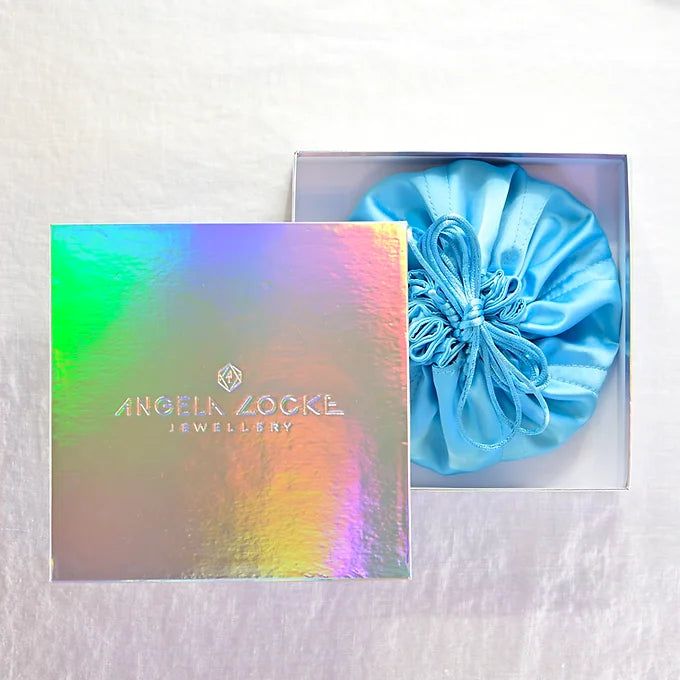 blue satin travel pouch in a branded box
