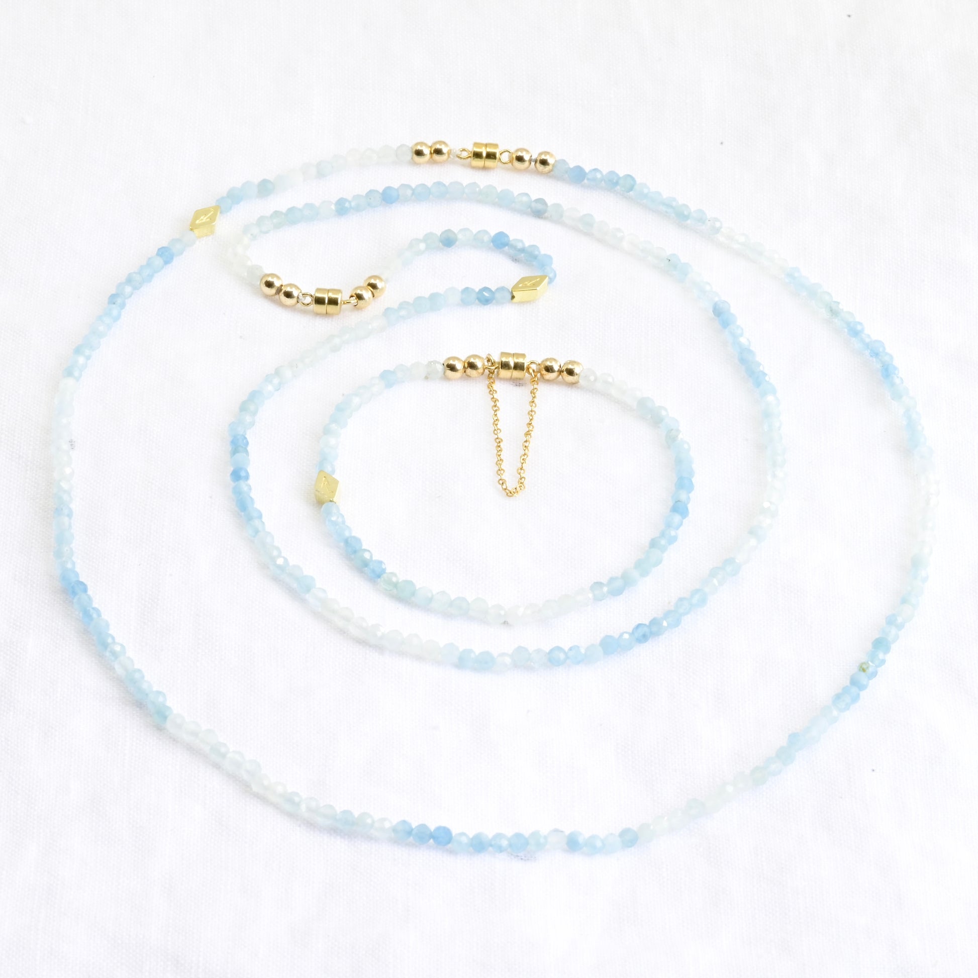 Set of beaded necklaces with gold accents on a white background