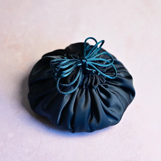 Blue drawstring pouch on a light gray background