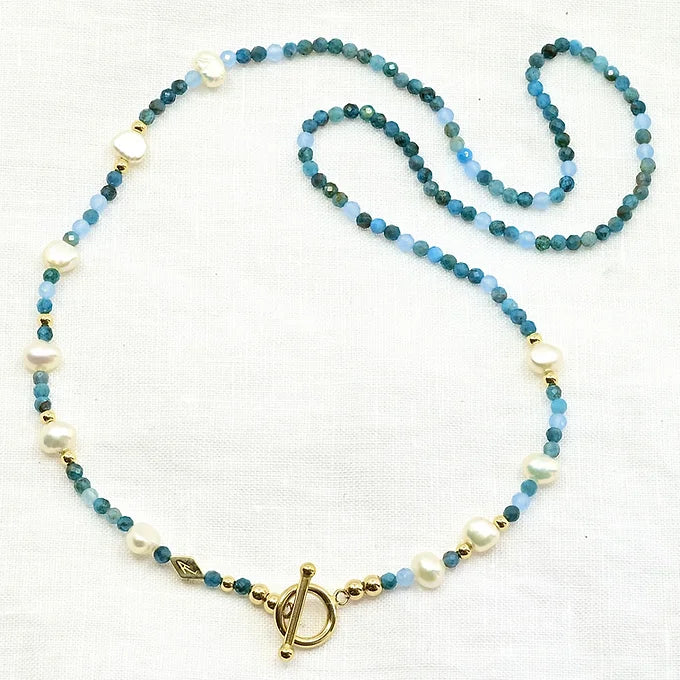 Necklace with blue and white beads and a gold clasp 