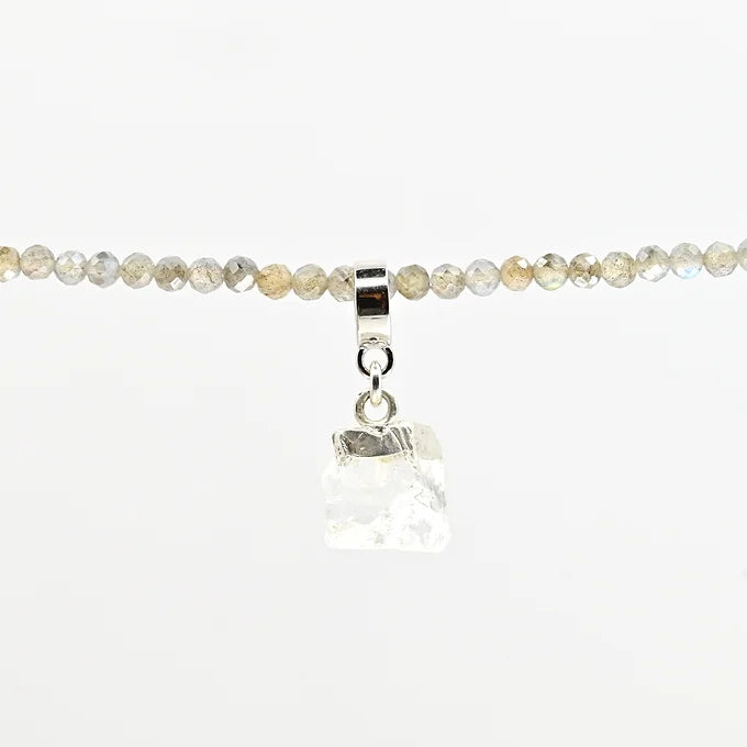Necklace with clear crystal pendant on a white background
