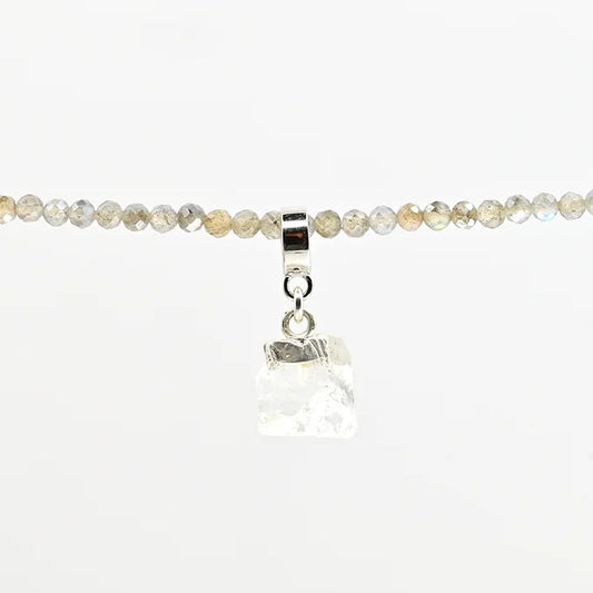 Necklace with clear crystal pendant on a white background