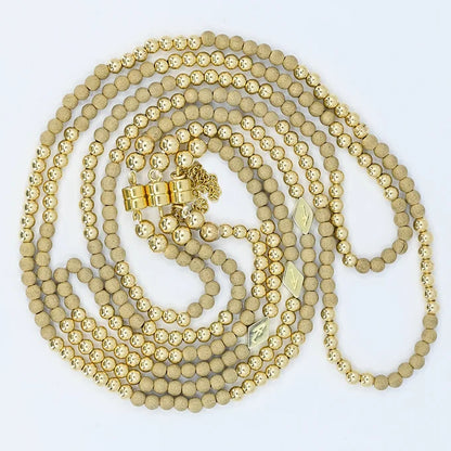 Gold beaded necklace on a white background