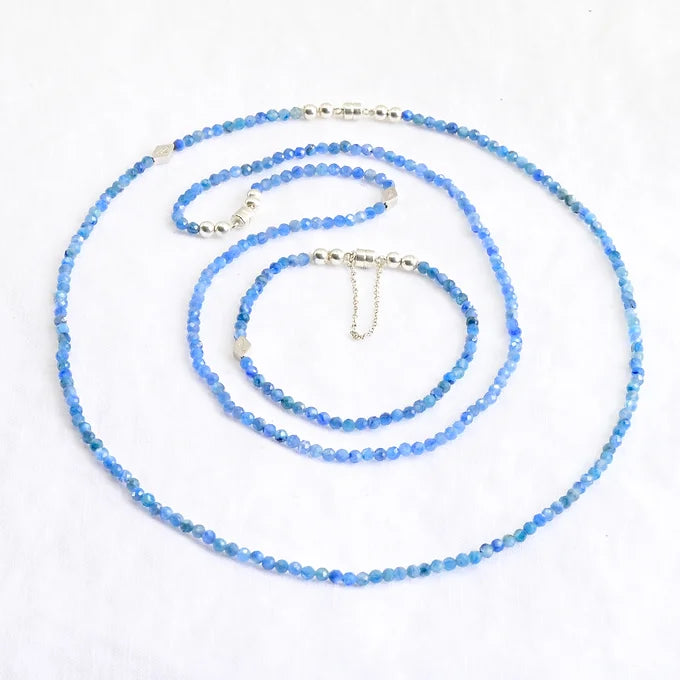 Blue beaded necklace on a white background