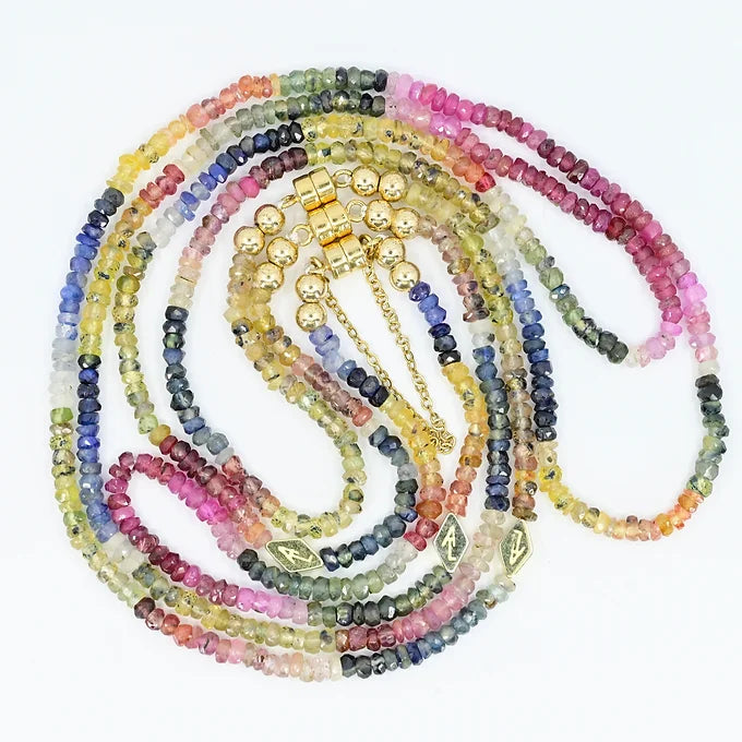 Multicolored beaded necklace with gold accents on a white background