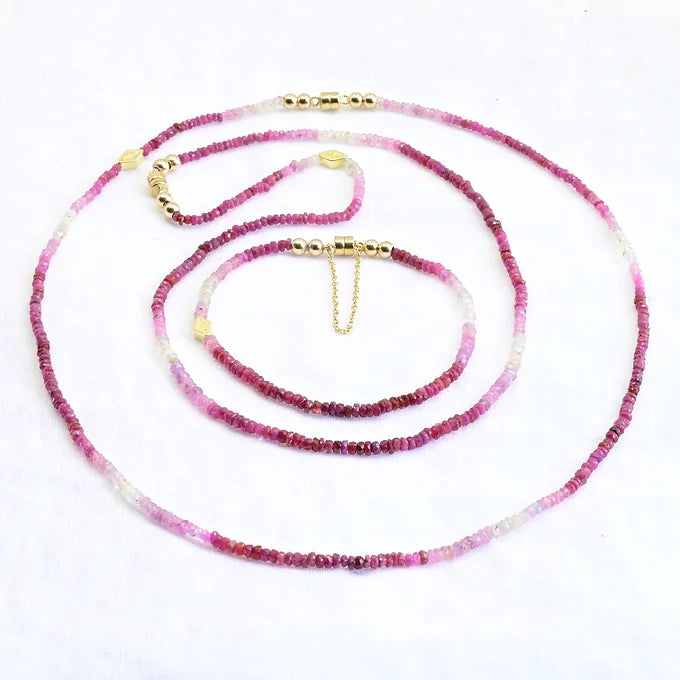 Necklace with pink and white beads on a white background