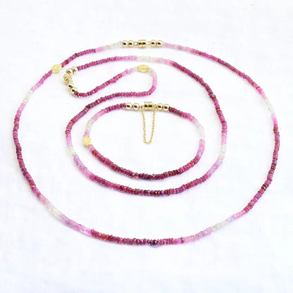 Necklace with pink and white beads on a white background