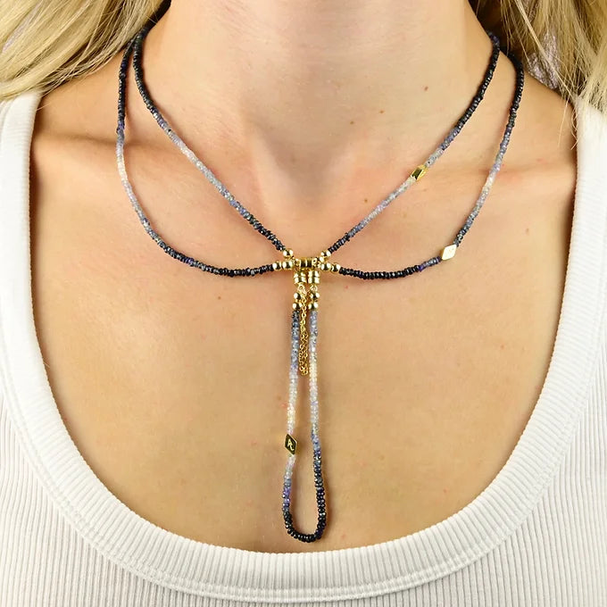 Necklace with beads and gold accents worn by a person