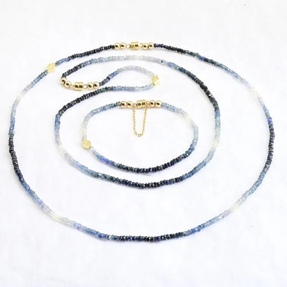 Necklace with blue and white beaded chain on a white background