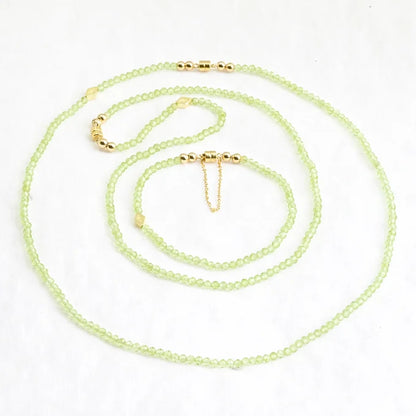 Necklace with green beads on a white background