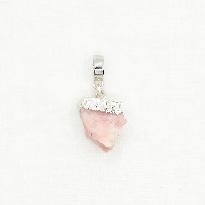 Pink stone pendant with silver accents on a white background