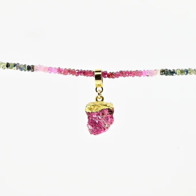 Necklace with multicolored beads and a pink pendant on a white background
