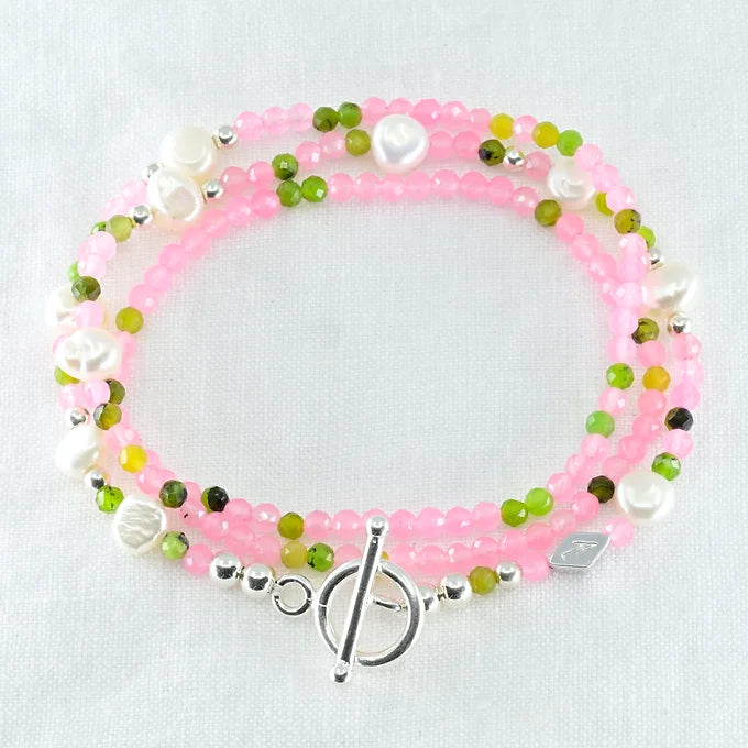 Beaded bracelet with pink, green, and white beads 