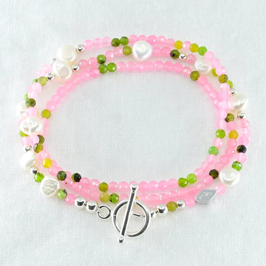 Beaded bracelet with pink, green, and white beads 