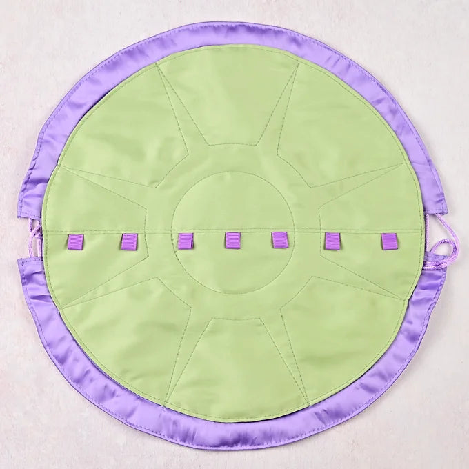 Round green mat with purple border and accents on a light gray background