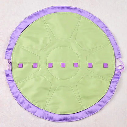 Round green mat with purple border and accents on a light gray background