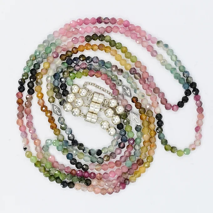 Multicolored beaded necklaces on a white background