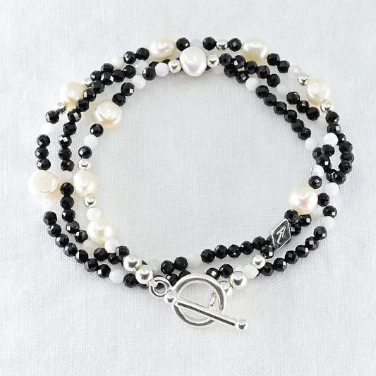 Beaded bracelet with black, white, and silver beads 