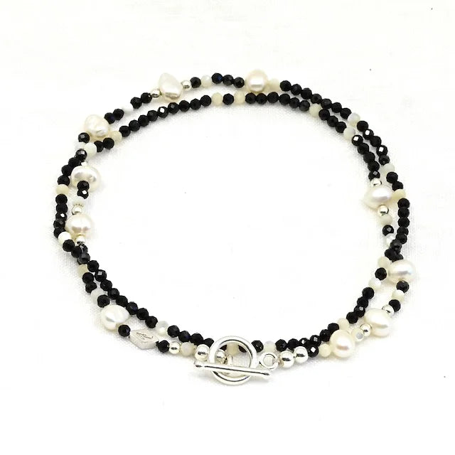 Black and white beaded bracelet with a silver clasp 