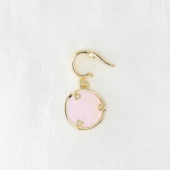 Gold earring with a pink crystal