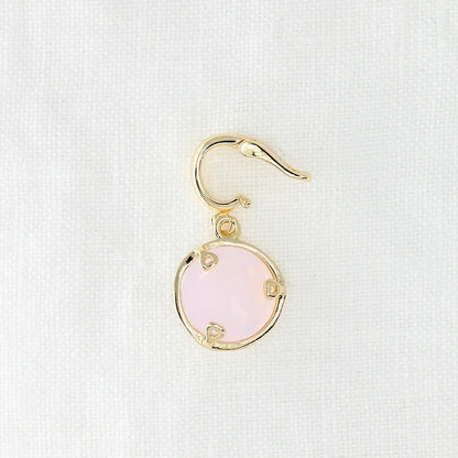 Gold earring with a pink crystal