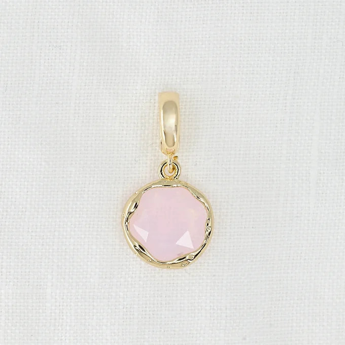 Gold pendant with a pink crystal
