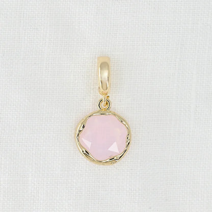 Gold pendant with a pink crystal