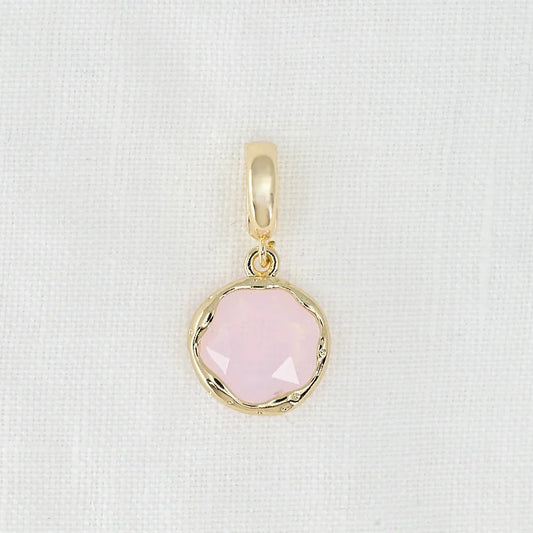 Gold pendant with a pink crystal