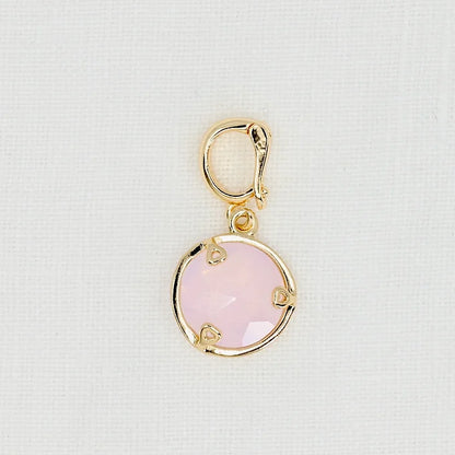 Gold pendant with a pink crystal 